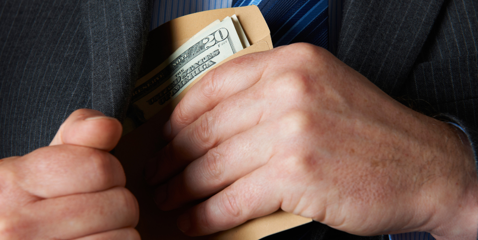 Money envelope being fit into jacket pocket