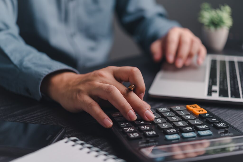 Businessman using calculator bookkeeping payroll