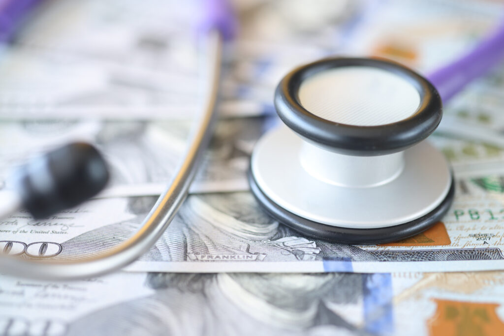 Medical stethoscope lying on american dollars