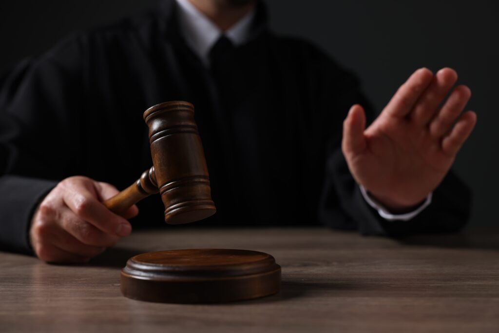 Judge with gavel showing stop gesture