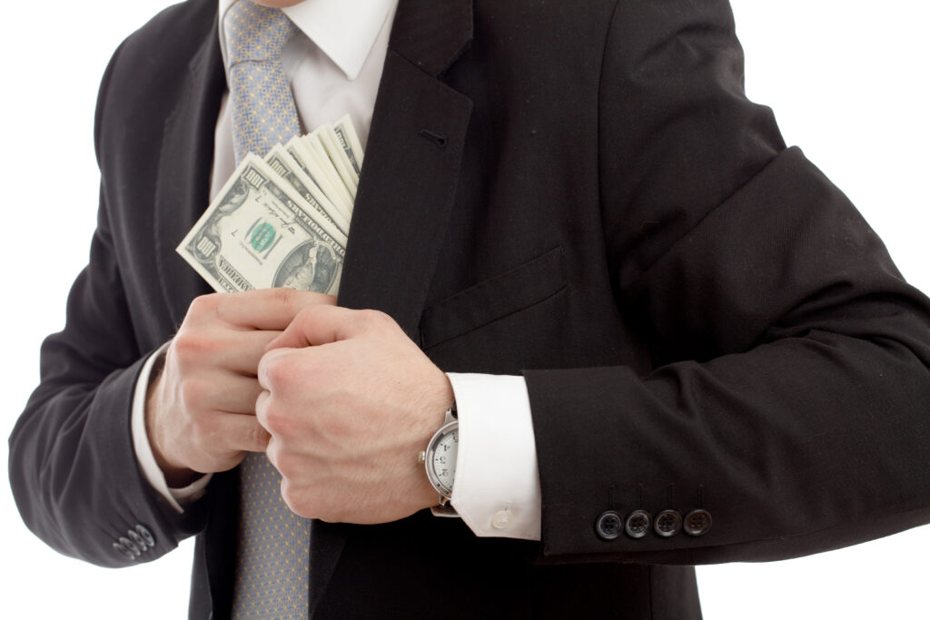 Man in a putting money in his pocket