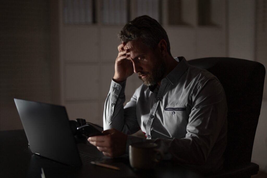 Tired businessman working late at night