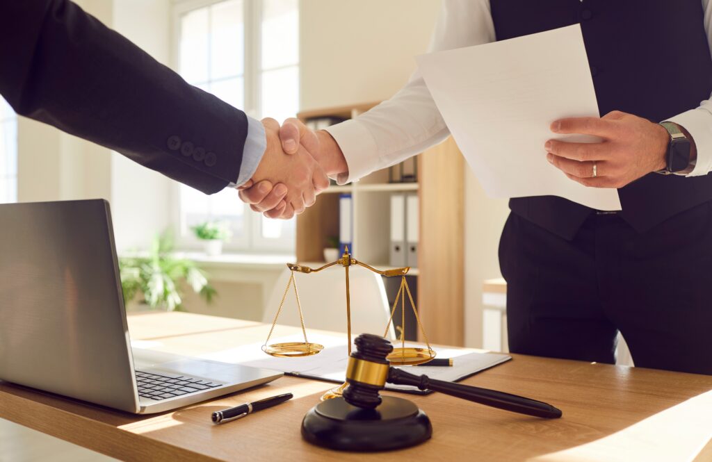 lawyer working in office shaking hand with a client